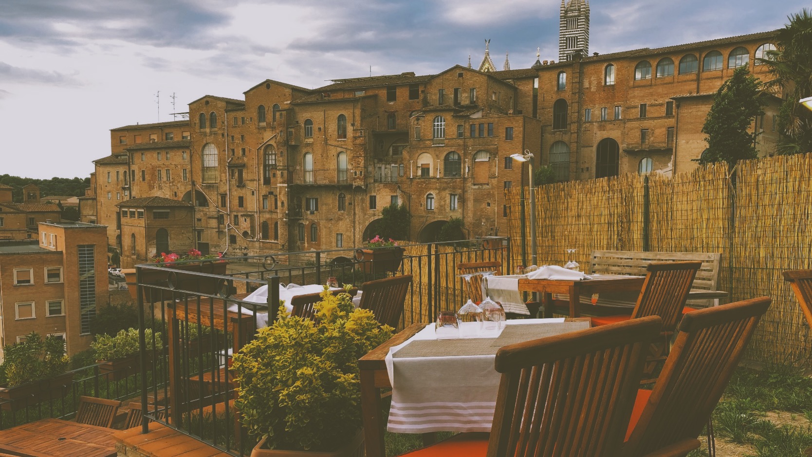 Restaurant patio overlooking city of orange brick buildings